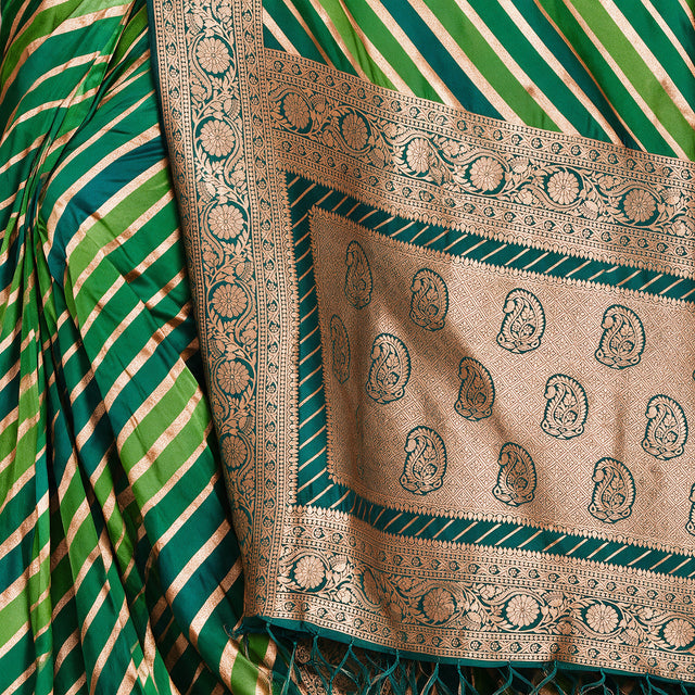 Green silk pallu close-up with paisley zari motifs and gold border