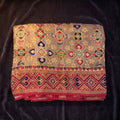 Grey viscose saree with multicolor geometric print and rani pink border, folded view