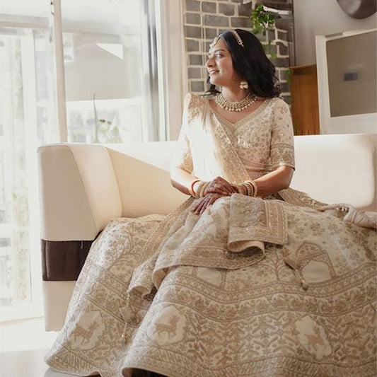 Beautiful ivory bridal lehenga with intricate embroidery, styled with matching jewelry and a dupatta