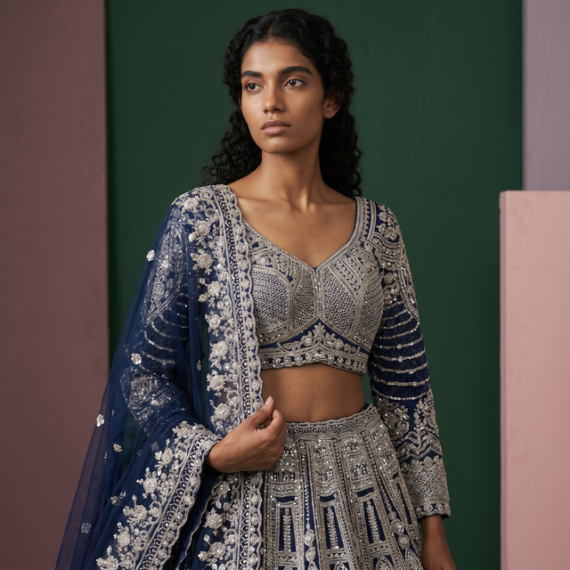 Embroidered navy blouse and lehenga skirt with scalloped silver trim and dupatta