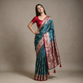 Satin Gifting Saree with Meenakari Arch Jaal & Contrast Border in teal with a red border, worn by a model