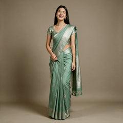 Mint green linen-cotton saree with zari butas and zari border, draped on model