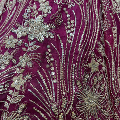 Magenta lehenga fabric with dense silver bead embroidery, floral motifs, and vertical lines