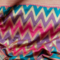 Teal, purple and pink zigzag art silk saree with gold zari highlights