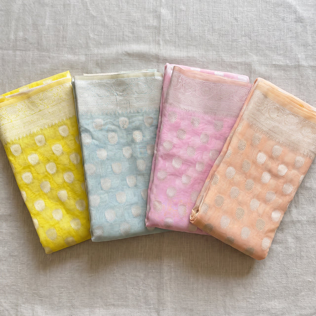 Pastel organza sarees with silver round buti in four colours
