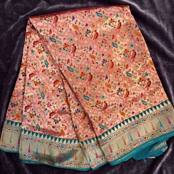 Peach printed viscose saree with floral jaal design and teal temple border