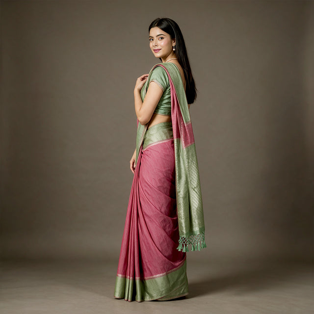 Pink linen-cotton saree with pista green zari border and draped pallu