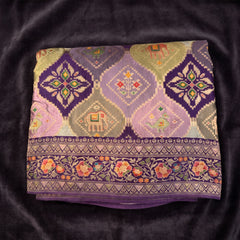 Purple viscose saree with geometric and animal motifs, floral border