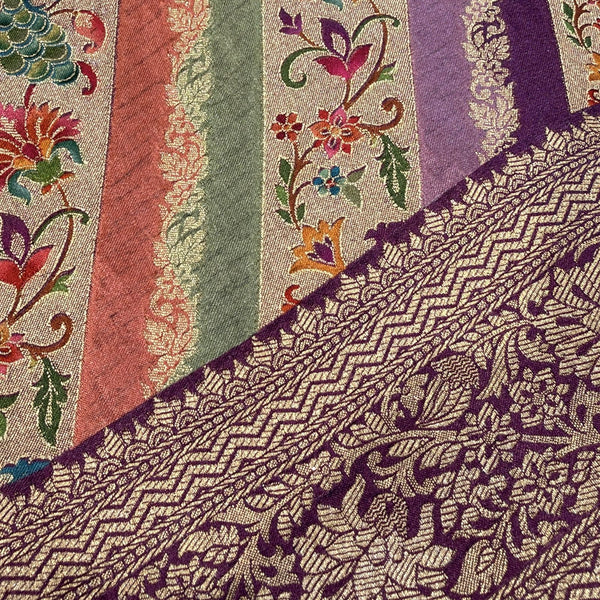 Close-up of purple saree border with detailed zari pattern and multicolor striped fabric