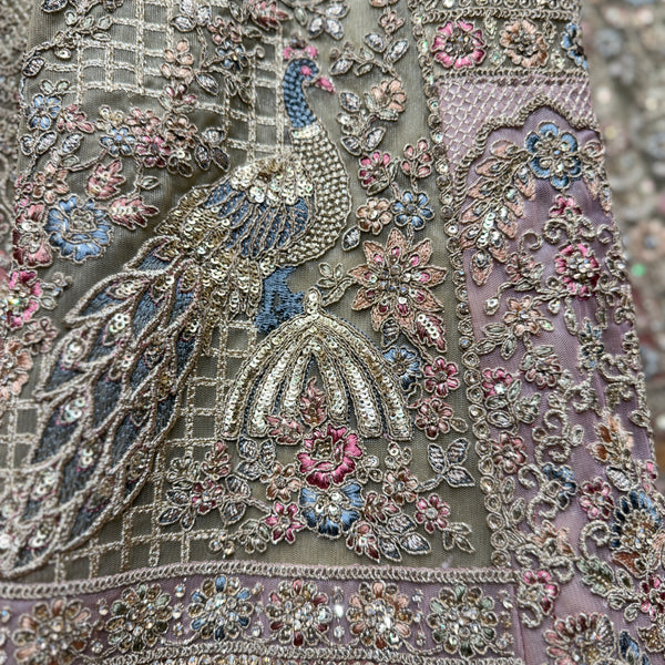 Close-up of sage green lehenga embroidery with peacock and floral motifs