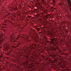 Red sequin and beadwork floral embroidery detail with raised texture