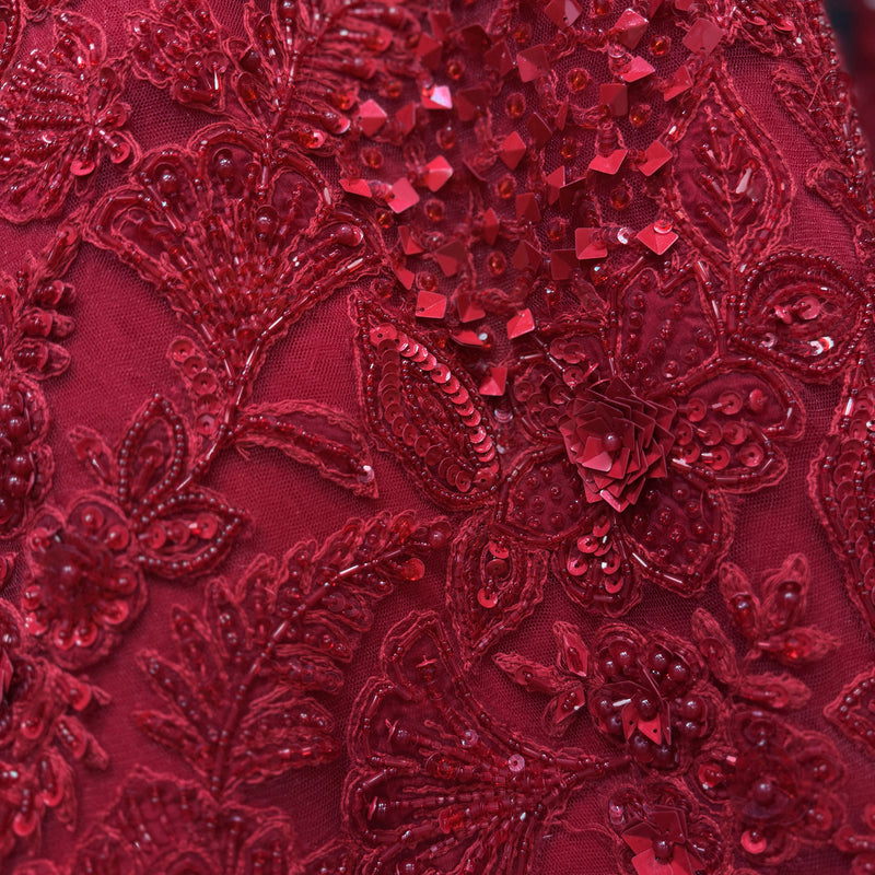 Red sequin and beadwork floral embroidery detail with raised texture
