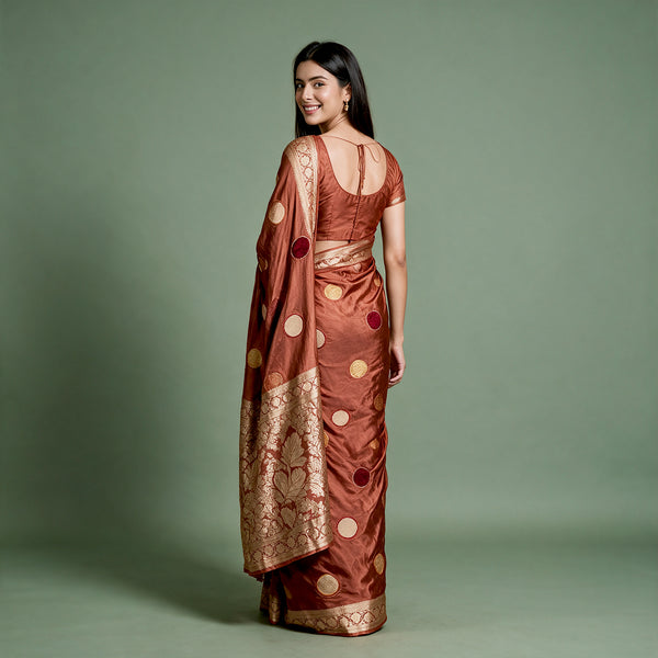 Rust satin saree with velvet polka dots and zari border, draped back view