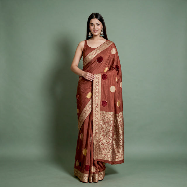 Rust satin saree with woven velvet polka dots and zari border, draped front view
