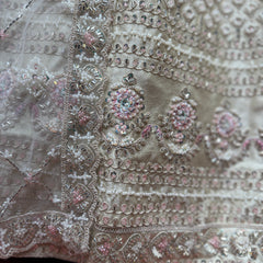 Ivory lehenga fabric close-up with silver, bead and floral sequin embroidery