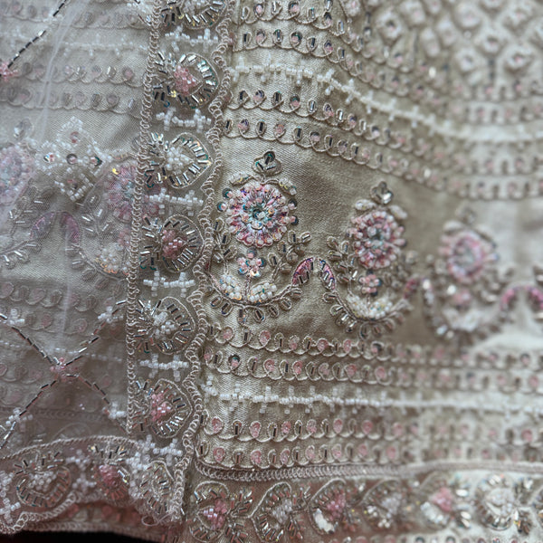 Ivory lehenga fabric close-up with silver, bead and floral sequin embroidery