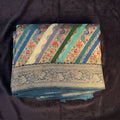 Teal Blue position print saree in pure viscose, folded view