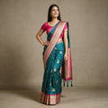 Teal Blue Banarasi Art Silk Saree with Zari Butas & Rani Pink Temple Border, worn by a model