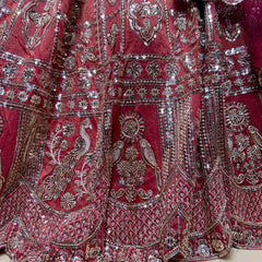 Embroidered bridal lehenga detailing with silver sequins on dark pink fabric