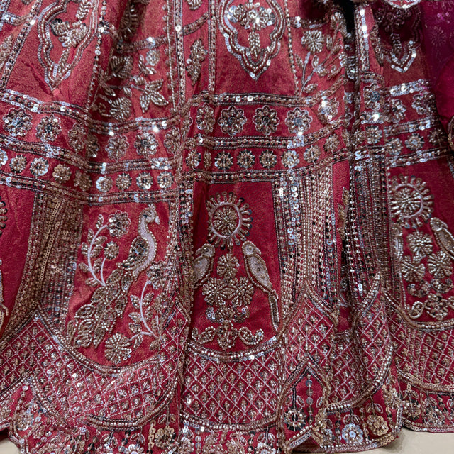 Embroidered bridal lehenga detailing with silver sequins on dark pink fabric