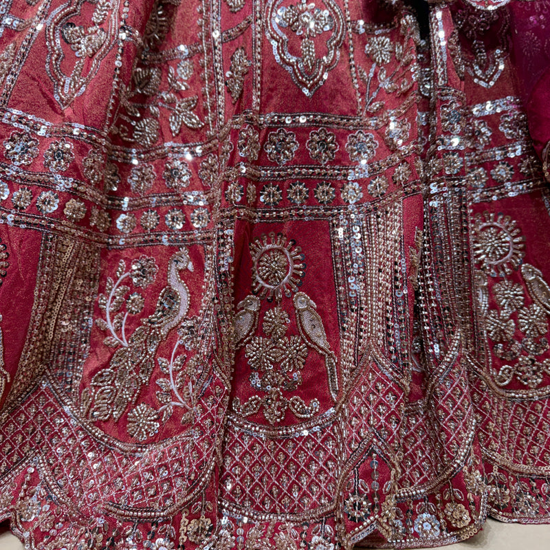 Embroidered bridal lehenga detailing with silver sequins on dark pink fabric