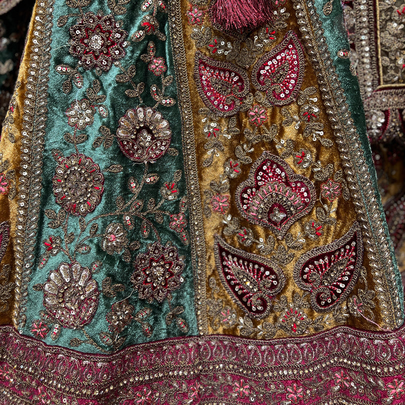 Intricately designed velvet maroon bridal lehenga with elaborate embroidery and rich colors