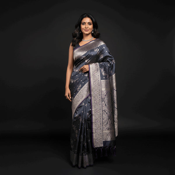 Charcoal satin silk saree with silver zari border and ornate pallu, draped