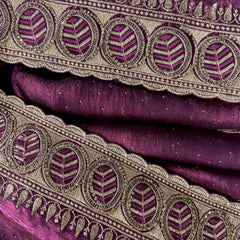 Closeup of wine tissue border with zari embroidery and round stone motifs