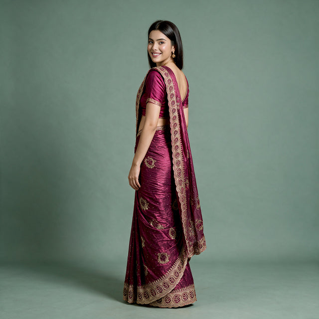 Wine tissue saree with zari and stonework border, ornate pallu, draped on model