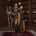 Teal silk saree with copper zari border and geometric square motifs, worn draped